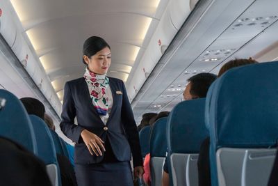 Rear view of woman sitting in airplane