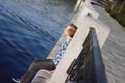 High angle portrait of smiling woman on railing