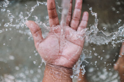 Close-up of man splashing water