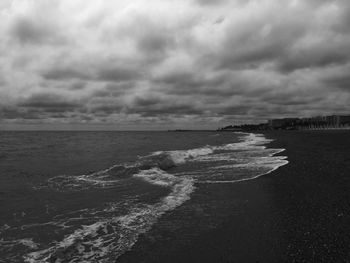 Scenic view of sea against cloudy sky