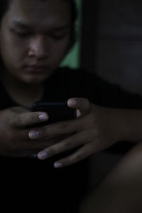 Close-up of man using mobile phone