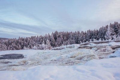 Scenic view of snow covered landscape against sky