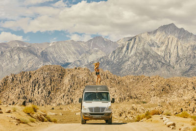 Panoramic view of car and mountains against sky