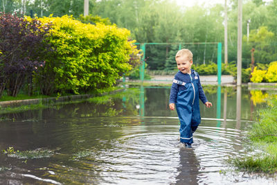 Portrait of young man standing in lake