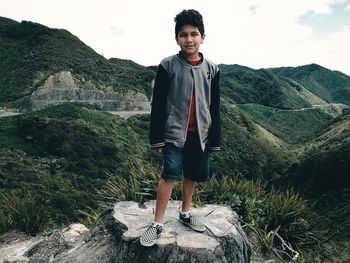 Portrait of young man standing on rock