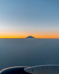 Close-up of airplane against clear sky during sunset