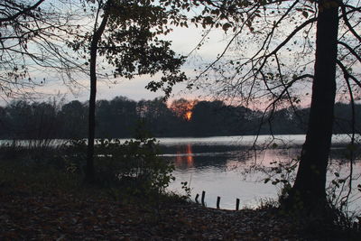 Scenic view of lake against sky during sunset