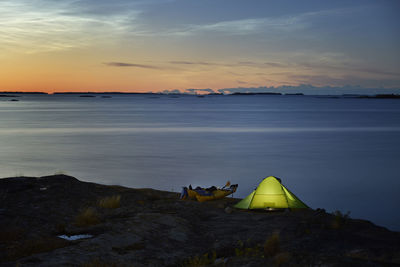 View of illuminated tent at sea