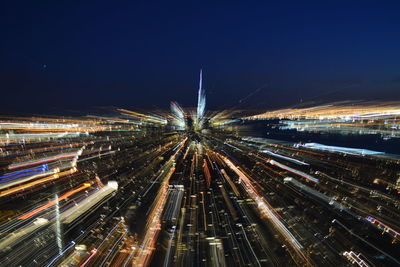 High angle view of light trails against sky at night