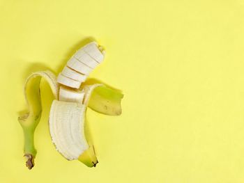 Close-up of bananas over yellow background