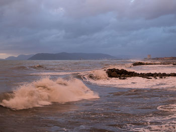 Scenic view of sea against dramatic sky