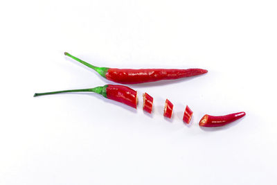 Close-up of red chili pepper against white background