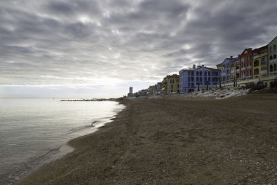 Scenic view of beach against sky during sunset
