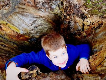 Funny boy hiding outdoors