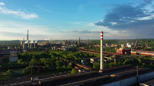 High angle view of railroad tracks by buildings against sky