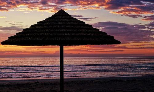 Scenic view of sea against orange sky