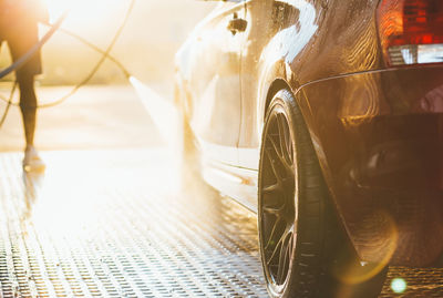 Low section of man washing car