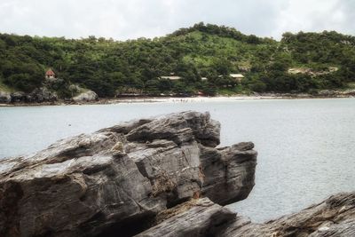 Rock formations by sea against sky