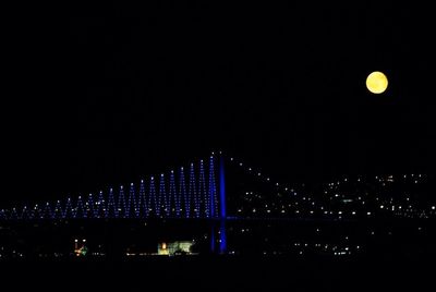 Illuminated bridge at night