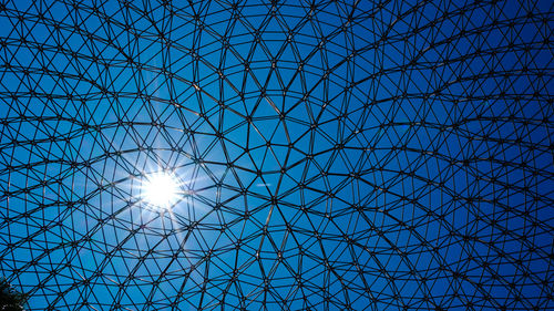 Low angle view of modern building against blue sky