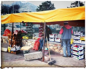 Rear view of man standing at market stall