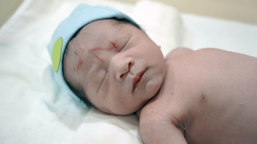 Baby boy sleeping on bed