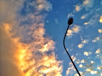 Low angle view of street light against cloudy sky