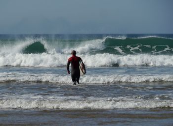 Full length of man at beach against sky