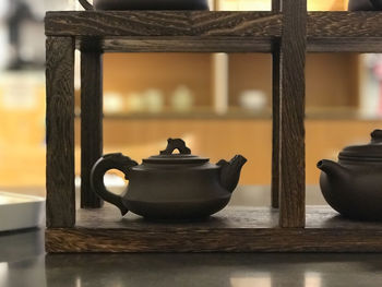 Close-up of teapot cup on a shelf 