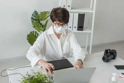 Young woman using digital tablet on table