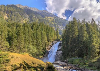 Scenic view of waterfall against sky