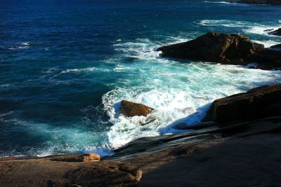 Scenic view of sea against rocks