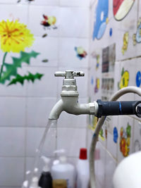 Close-up of faucet in bathroom