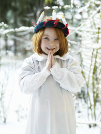 Girl wearing traditional lucia costume standing outdoors