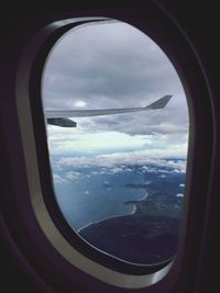 Scenic view of sea seen through airplane window