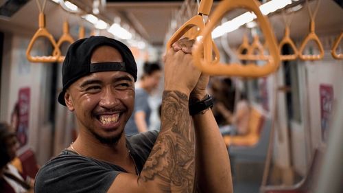 Portrait of smiling man on metro
