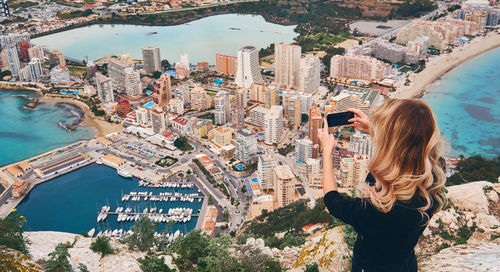 Woman standing by buildings in city