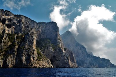 Scenic view of sea and mountains against sky