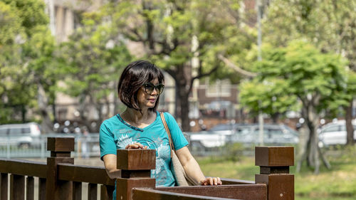 Portrait of a smiling young woman sitting on table