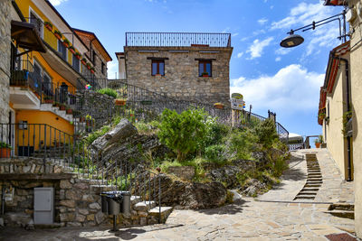 A narrow street between the old houses of sasso di castalda, a village of basilicata region, italy.