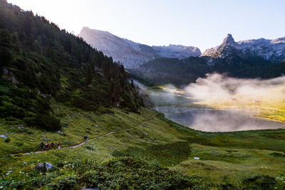 Scenic view of berchtesgaden alps against clear sky in foggy weather