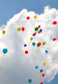 Low angle view of balloons against sky