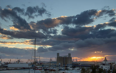 Sailboats in marina at sunset