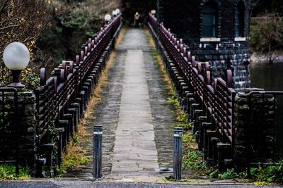 Bollards at bridge over lake in city