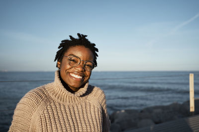 Portrait of young man against sea during sunset