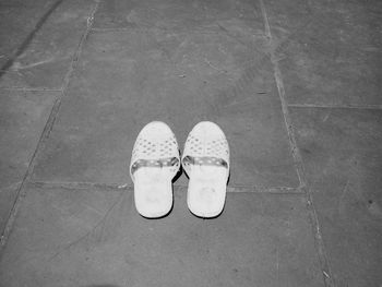 Low section of man standing on tiled floor