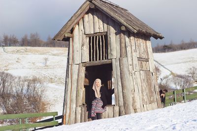 Woman standing on field during winter