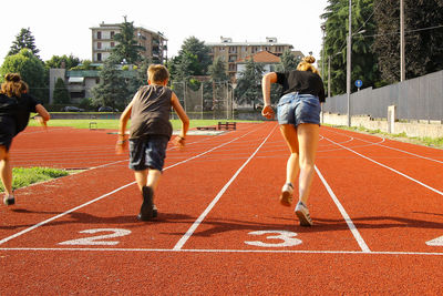 Rear view of people running on walkway