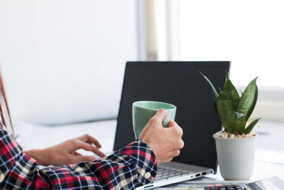 Midsection of man using mobile phone
