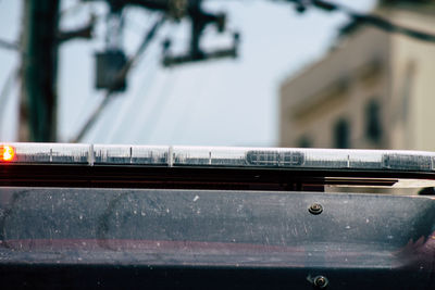 Close-up of car on railing in city